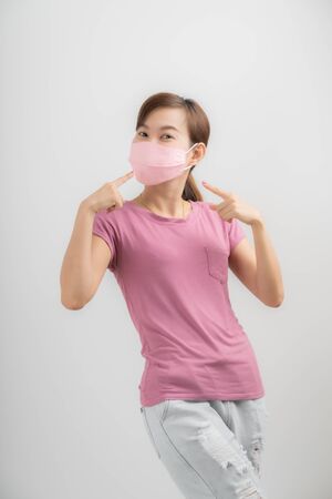Close up portrait of young woman with medicine health care mask against white white background. CoronaVirus, Covid-19. Asian peopleの写真素材