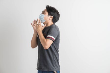 Portrait of young man with medicine health care mask against white gray background. Asian peopleの写真素材