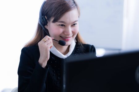 Asian young woman working in call centreの写真素材