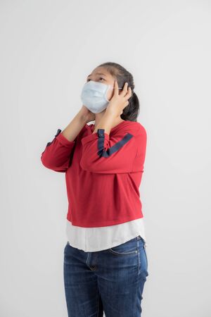 Close up portrait of young woman with medicine health care mask against white white background. CoronaVirus, Covid-19. Asian peopleの写真素材