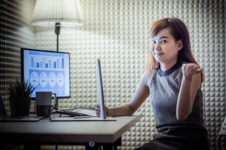 Asian business woman reviewing data in financial charts and graphs. Accountingの写真素材