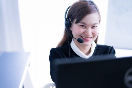 Asian young woman working in call centreの写真素材