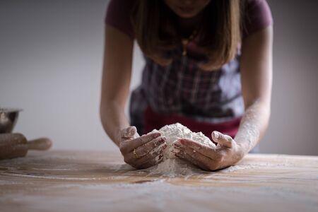 Making dough by female hands at bakeryの写真素材