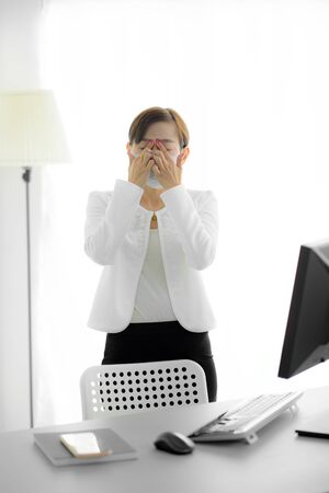 Asian woman using the medical face mask in officeの写真素材