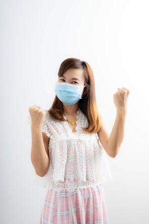 Close up portrait of young woman with medicine health care mask against white white background. CoronaVirus, Covid-19. Asian peopleの写真素材