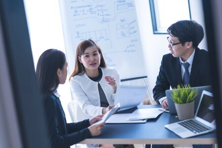 Group of business people busy discussing financial matter during meeting. Asian peopleの写真素材