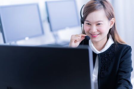 Asian young woman working in call centreの写真素材