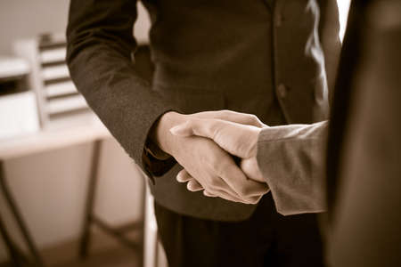 Businessman shaking hands to seal a deal with his partnerの写真素材