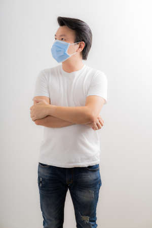 Portrait of young man with medicine health care mask against white gray background. Asian peopleの写真素材