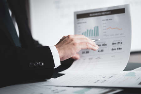 Businessman analyzing investment charts with laptop. Accounting conceptの写真素材