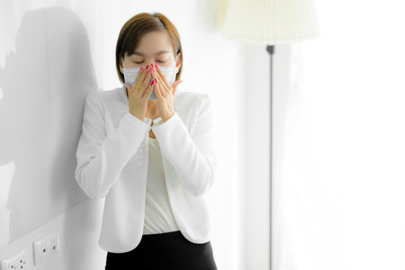 Asian woman using the medical face mask in officeの写真素材