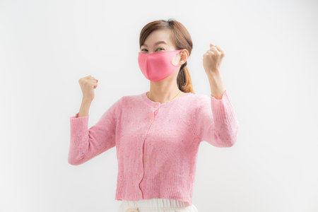 Close up portrait of young woman with medicine health care mask against white white background. CoronaVirus, Covid-19. Asian peopleの写真素材