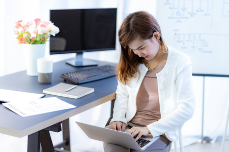 Young woman working at home or in a small office. Asian Peopleの写真素材