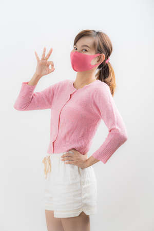 Close up portrait of young woman with medicine health care mask against white white background. CoronaVirus, Covid-19. Asian peopleの写真素材