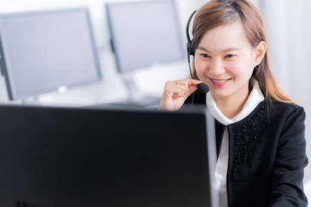 Asian young woman working in call centreの写真素材