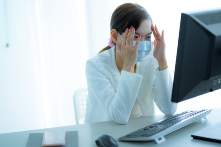Asian woman using the medical face mask in officeの写真素材