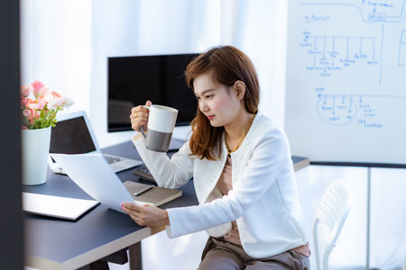 Young woman working at home or in a small office. Asian Peopleの写真素材