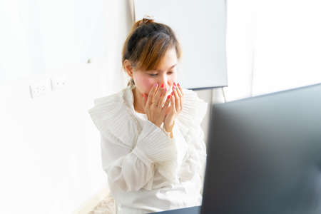 Business woman with back pain in office. Asian people. Work at home concept