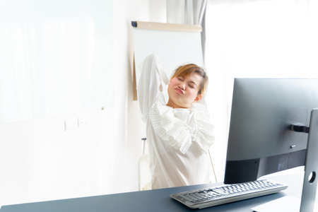 Business woman with back pain in office. Asian people. Work at home conceptの写真素材