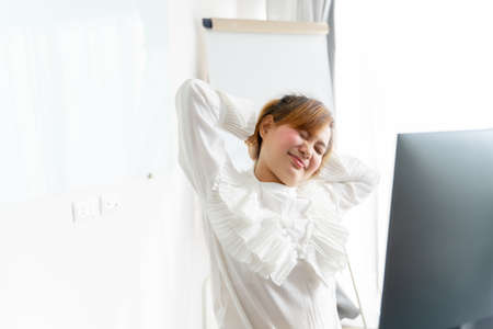 Business woman with back pain in office. Asian people. Work at home conceptの写真素材