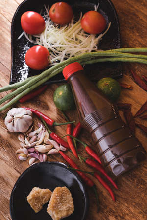Various fresh vegetables and spices on wooden tableの写真素材
