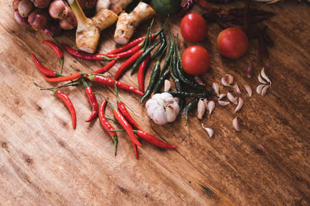 Various fresh vegetables and spices on wooden tableの写真素材