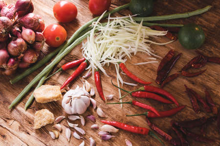 Various fresh vegetables and spices on wooden tableの写真素材