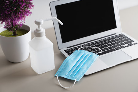 Surgical masks for protection against on laptop. Work Stay Homeの写真素材