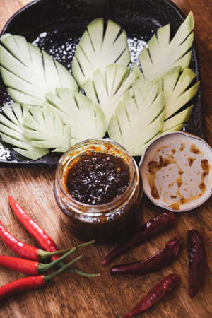 Various fresh vegetables and spices on wooden tableの写真素材