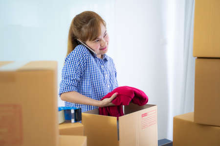 Entrepreneur owner receive and checking online purchase shopping order to preparing pack product box. Selling online ideas concept. Startup small businessの写真素材