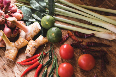 Various fresh vegetables and spices on wooden tableの写真素材