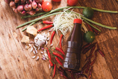 Various fresh vegetables and spices on wooden tableの写真素材