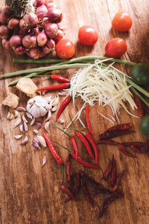 Various fresh vegetables and spices on wooden tableの写真素材
