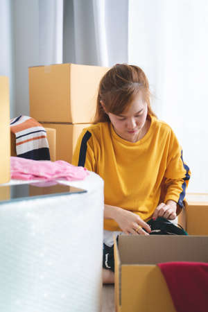 Asian young owner business woman working online shopping at home. Selling online ideas conceptの写真素材
