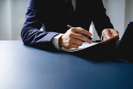 Businessman doing finances and calculate about cost to investment , business Financing Accounting Banking Concept, tax systemの写真素材