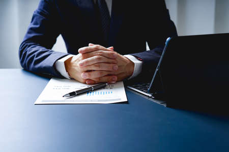 Businessman doing finances and calculate about cost to investment , business Financing Accounting Banking Concept, tax systemの写真素材