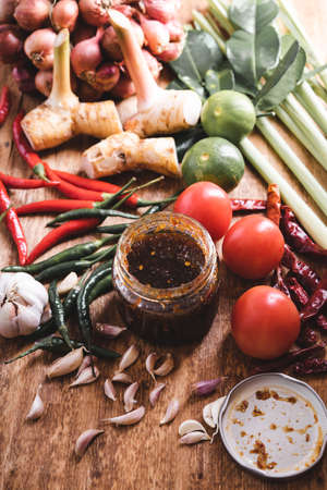 Various fresh vegetables and spices on wooden tableの写真素材