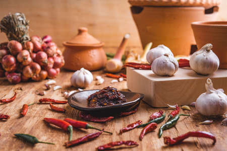 Various fresh vegetables and spices on wooden tableの写真素材