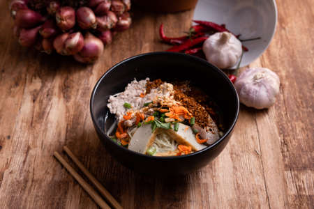 Thai Noodle , Bowl of noodles with spices on wooden background, Thai noodles soup, Table top viewの写真素材