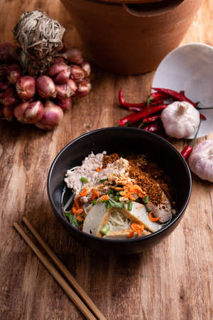 Thai Noodle , Bowl of noodles with spices on wooden background, Thai noodles soup, Table top viewの写真素材