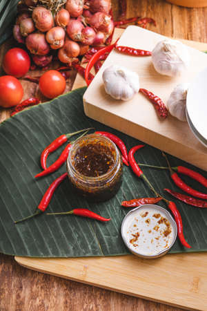 Various fresh vegetables and spices on wooden tableの写真素材