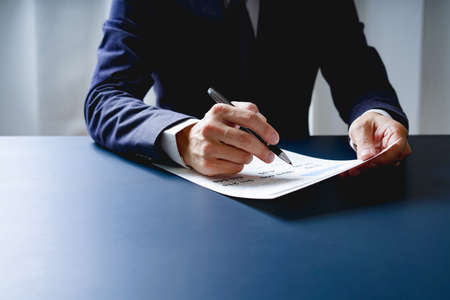 Businessman doing finances and calculate about cost to investment , business Financing Accounting Banking Concept, tax systemの写真素材