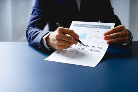Businessman doing finances and calculate about cost to investment , business Financing Accounting Banking Concept, tax systemの写真素材