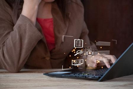 chat AI, Woman using laptop computer with business icon on screen. Internet and technology concept.の写真素材