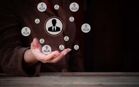businesswoman hand with social network icon on dark background, human resources concept, Customer or employees care concept, Teamwork, network and community concept.の写真素材
