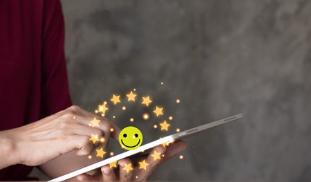Customer service satisfaction survey concept with smiley face drawn on tablet screen.の写真素材