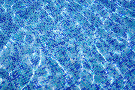defocus blurred blue water in pool rippled water background. Swimming pool texture, water wave under texture background.の写真素材