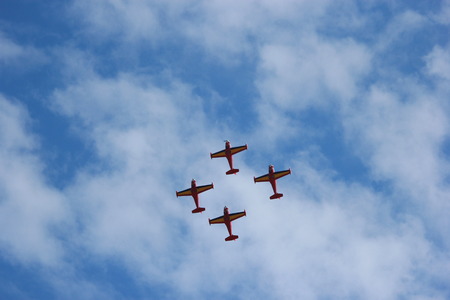 stunt civilian planes flying in synchronization.
