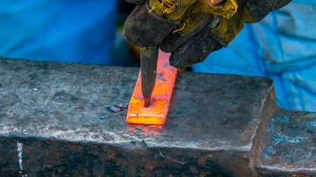 Detailed shot of metal being worked at a blacksmithing forgeの写真素材