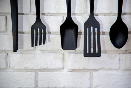 Kitchen utensils on the light brick background. Kitchenware and cooking ingrediants at home. Kitchen background and utensils.の写真素材